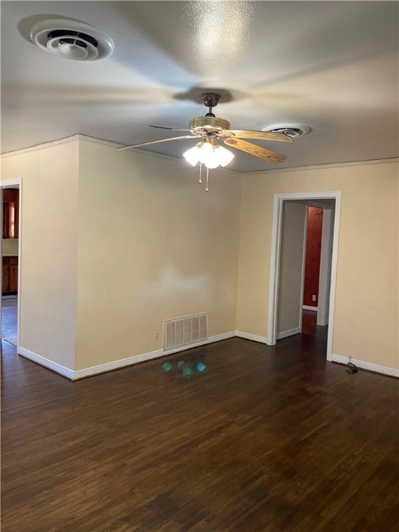 spare room with dark wood-type flooring and ceiling fan