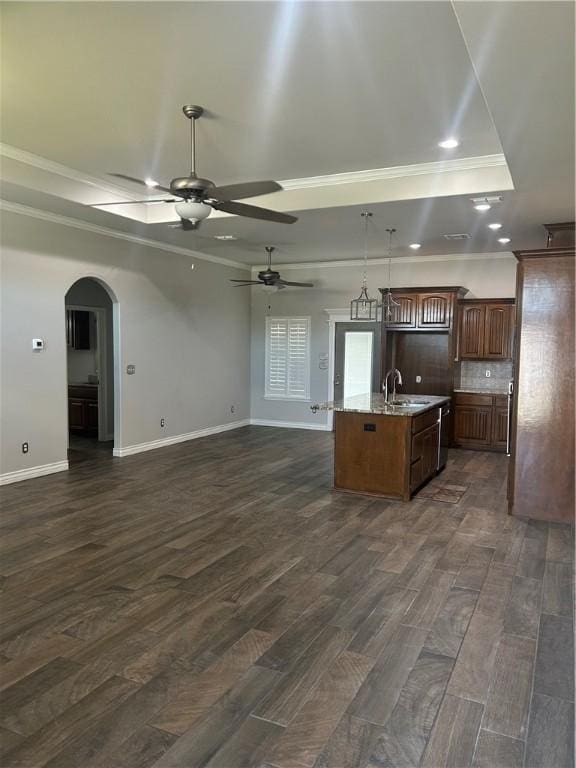 119 Moss, Odem, TX 78370 - kitchen with ornamental molding, open floor plan, a raised ceiling, a sink, and dark wood-type flooring