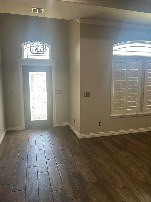 119 Moss, Odem, TX 78370 - entrance foyer with dark wood finished floors, baseboards, and ornamental molding