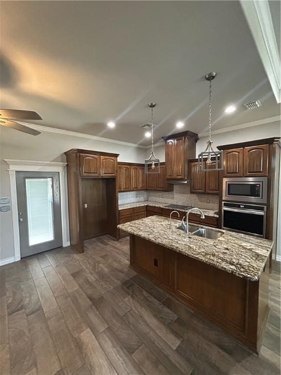 119 Moss, Odem, TX 78370 - kitchen with appliances with stainless steel finishes, a sink, a ceiling fan, tasteful backsplash, and crown molding