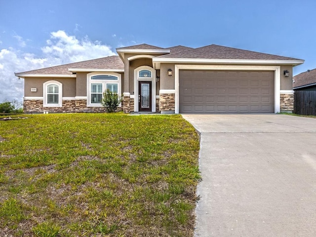 119 Moss, Odem, TX 78370 - view of front of property with stucco siding, stone siding, a front yard, and driveway