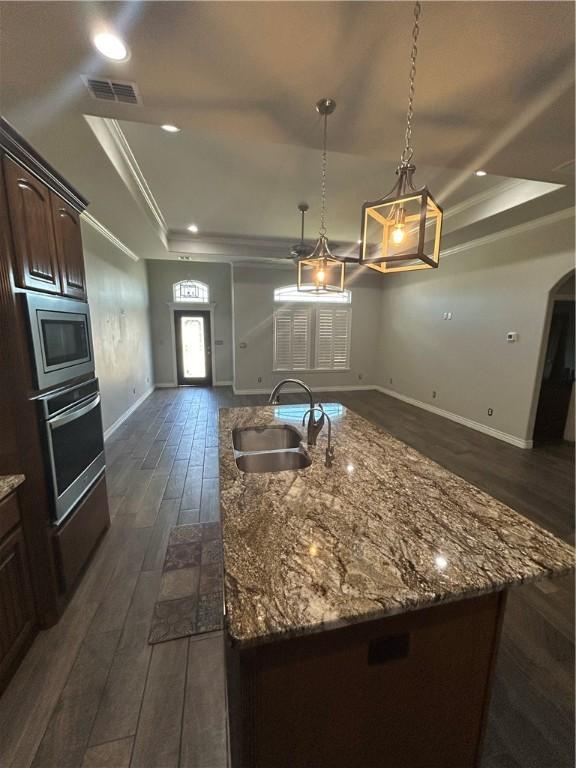119 Moss, Odem, TX 78370 - kitchen with a raised ceiling, a sink, stainless steel appliances, open floor plan, and crown molding