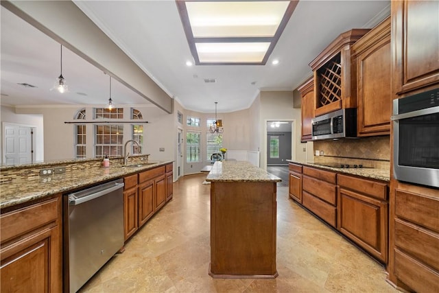 5609 Leicester Dr, Corpus Christi, TX 78414 - kitchen with stainless steel appliances, a center island, brown cabinets, decorative backsplash, and crown molding