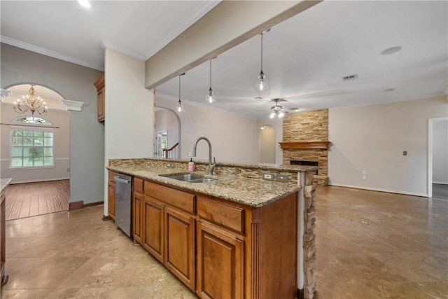 5609 Leicester Dr, Corpus Christi, TX 78414 - kitchen featuring ceiling fan, brown cabinetry, a stone fireplace, ornamental molding, and open floor plan