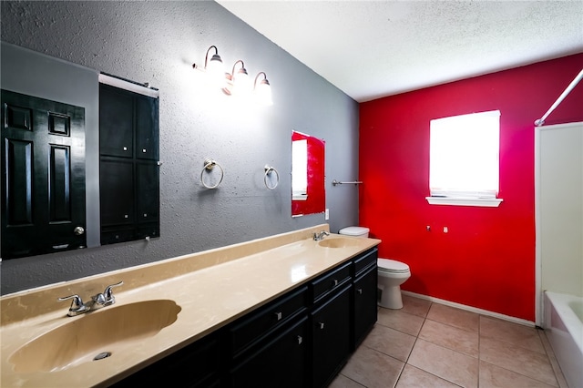 bathroom with vanity, tile patterned floors, and toilet