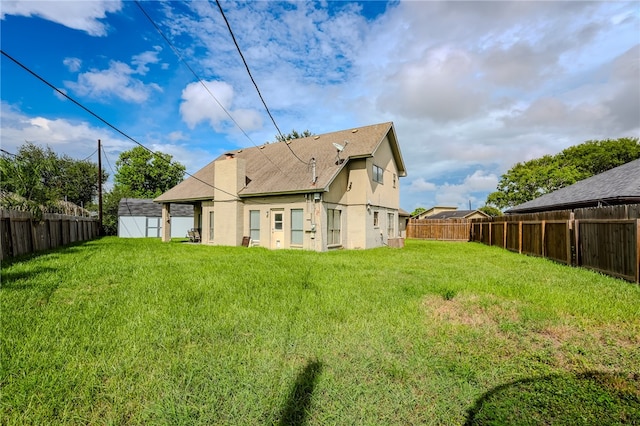 back of house featuring a yard