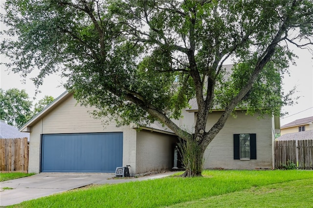 view of front of home with a garage and a front lawn