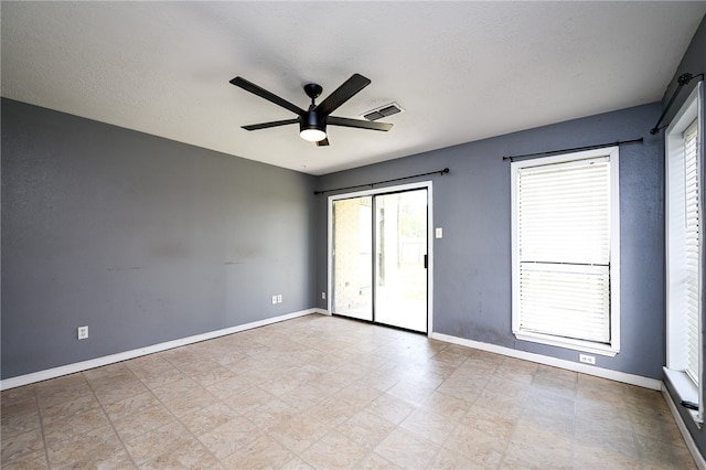 unfurnished room with a textured ceiling and ceiling fan