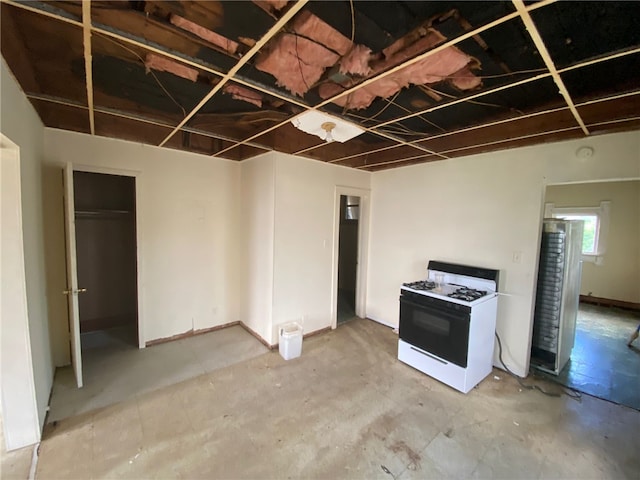 kitchen featuring concrete flooring and white gas range