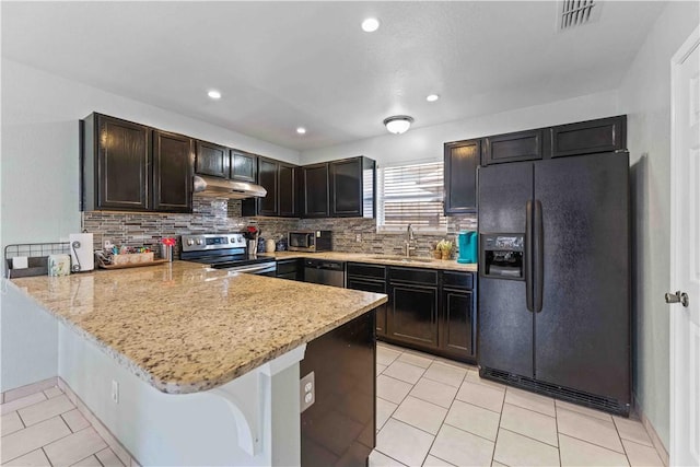 kitchen with backsplash, sink, light stone counters, kitchen peninsula, and stainless steel appliances