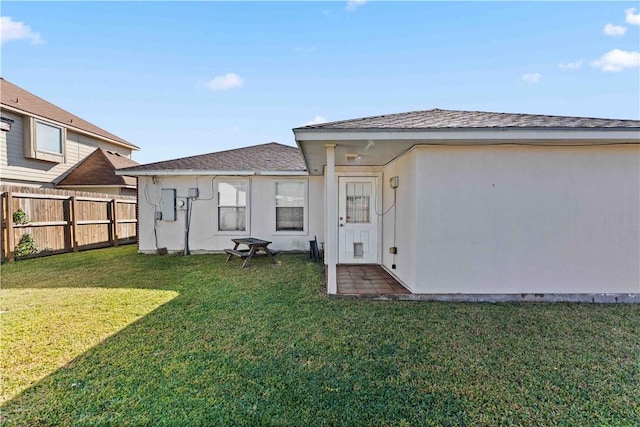 back of house featuring a yard