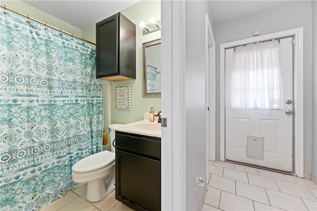 bathroom featuring toilet, vanity, and tile patterned floors