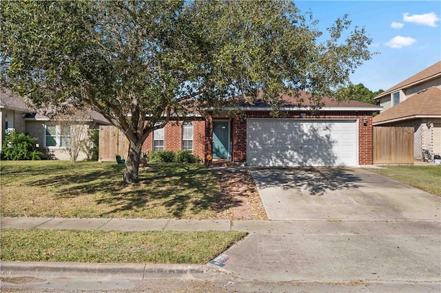 view of front of property with a front yard and a garage