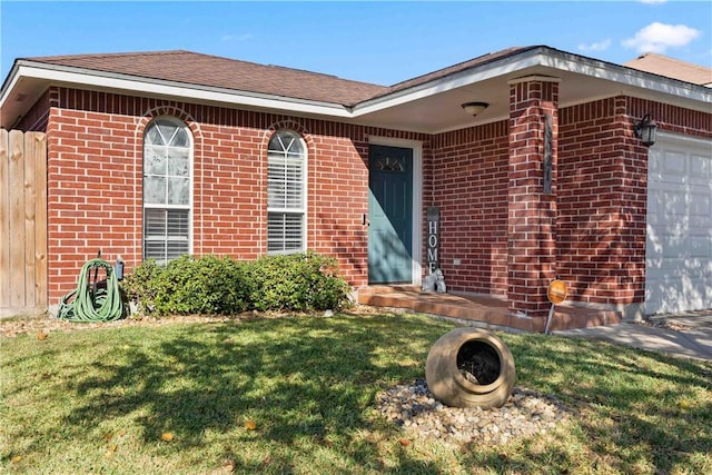 entrance to property with a yard and a garage