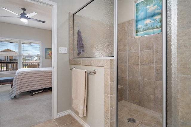 bathroom featuring tile patterned flooring, ceiling fan, and a shower with door