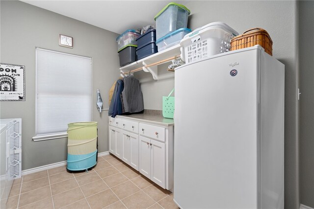 clothes washing area featuring light tile patterned floors