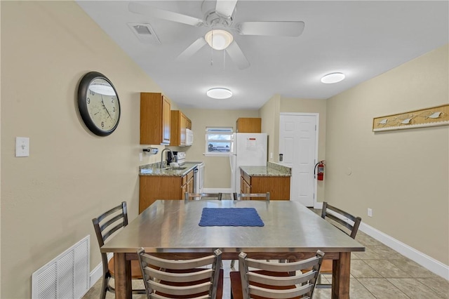 tiled dining area featuring ceiling fan