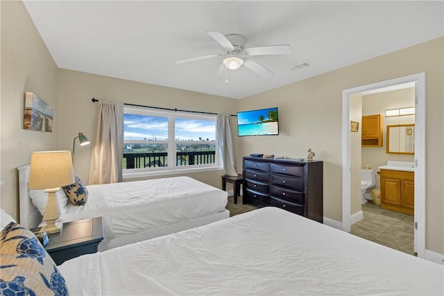 bedroom featuring ceiling fan, ensuite bath, and light tile patterned floors