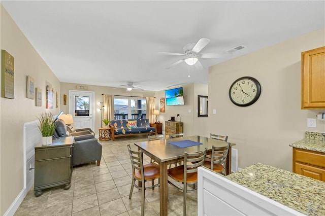 tiled dining room featuring ceiling fan