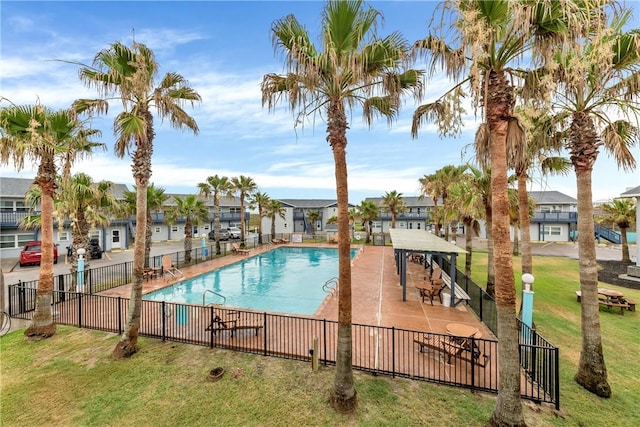 view of swimming pool with a lawn and a patio