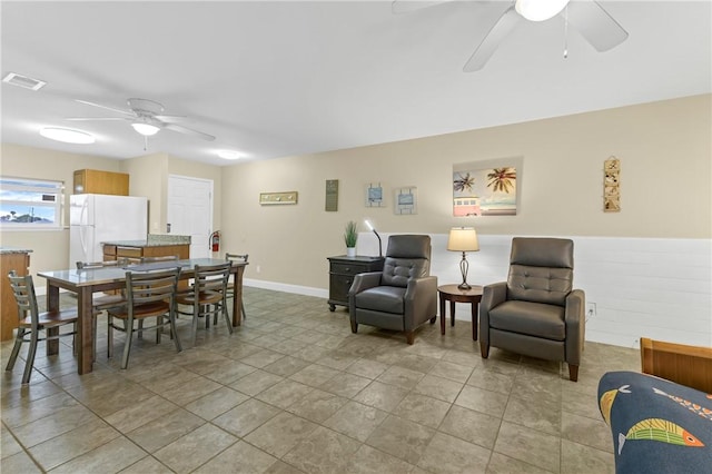 interior space with ceiling fan and light tile patterned floors