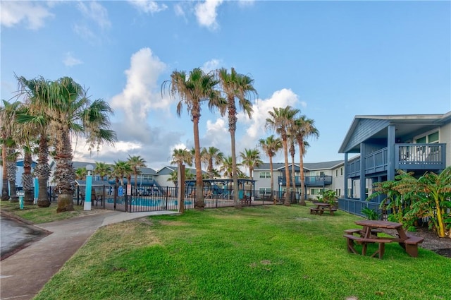 surrounding community featuring a lawn and a pool