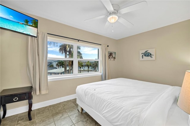 tiled bedroom with ceiling fan