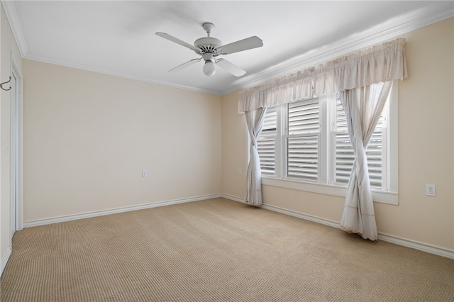 carpeted empty room with ornamental molding and ceiling fan