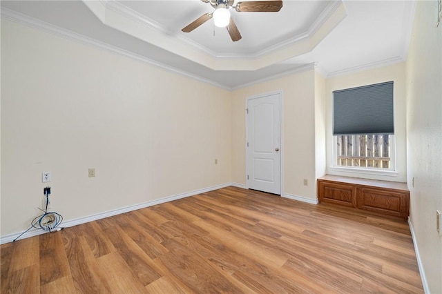 119 N Rife St, Aransas Pass, TX 78336 - spare room with a raised ceiling, light wood-type flooring, ornamental molding, ceiling fan, and baseboards