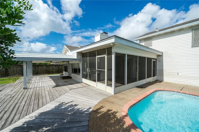 119 N Rife St, Aransas Pass, TX 78336 - rear view of property featuring a sunroom, a deck, and a chimney
