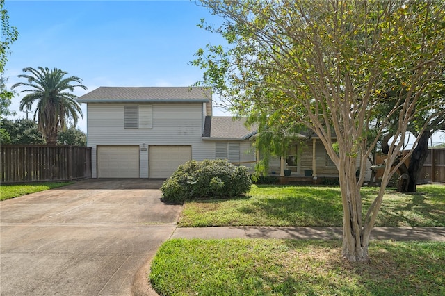 view of front of property featuring a front lawn and a garage