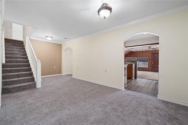 119 N Rife St, Aransas Pass, TX 78336 - unfurnished living room with arched walkways, ceiling fan, ornamental molding, carpet, and stairway