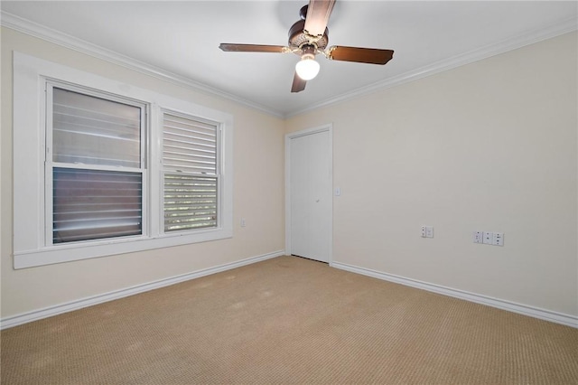 119 N Rife St, Aransas Pass, TX 78336 - spare room with light colored carpet, baseboards, ceiling fan, and ornamental molding