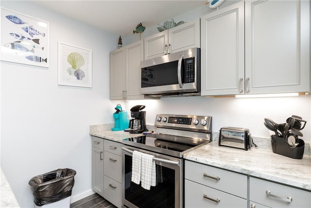 kitchen featuring light stone counters and stainless steel appliances