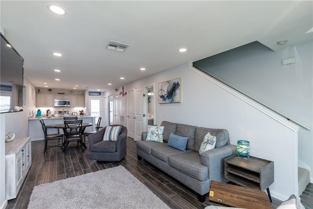 living area with wood tiled floor, visible vents, stairway, and recessed lighting