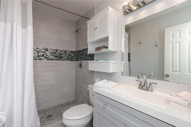 full bath featuring vanity, a shower stall, and toilet