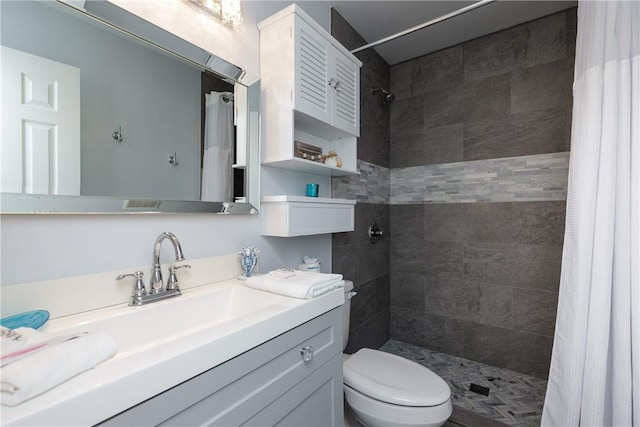 full bathroom with a shower stall, toilet, and vanity