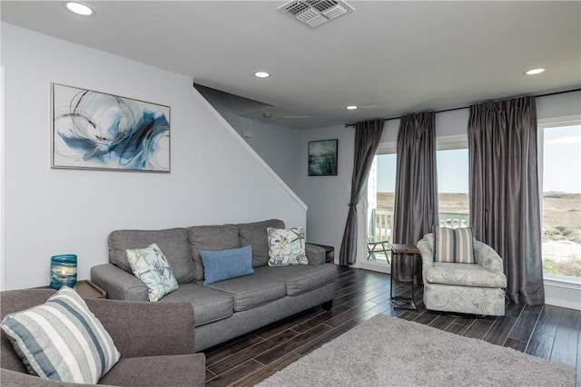 living room featuring wood finish floors, a healthy amount of sunlight, visible vents, and recessed lighting