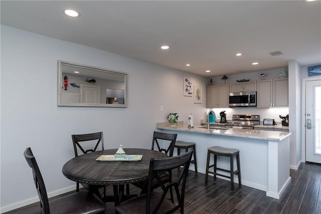 dining space with recessed lighting, visible vents, and dark wood finished floors