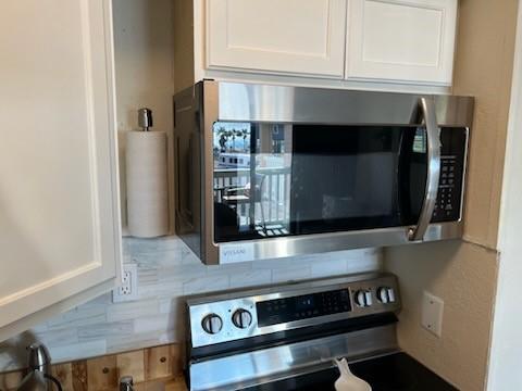 details with white cabinets and stainless steel appliances