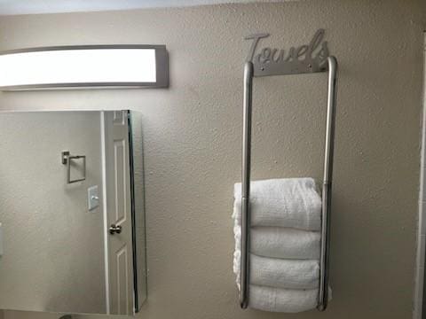 bathroom featuring a textured wall