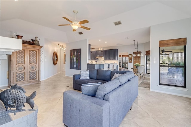 living room featuring lofted ceiling, ceiling fan, and light tile patterned floors