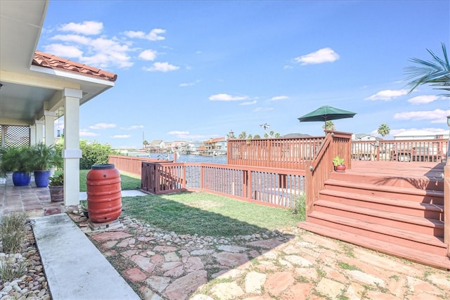 view of yard featuring a wooden deck and a patio