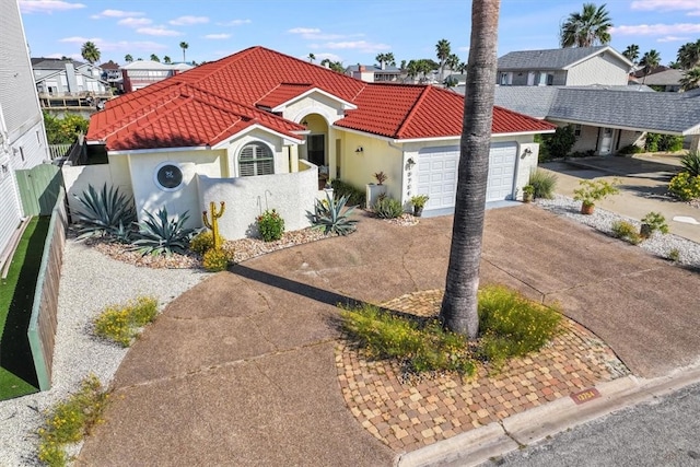 mediterranean / spanish house with a garage