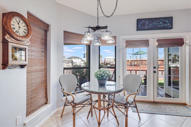 tiled dining room with a notable chandelier