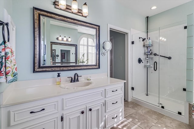 bathroom featuring vanity and an enclosed shower