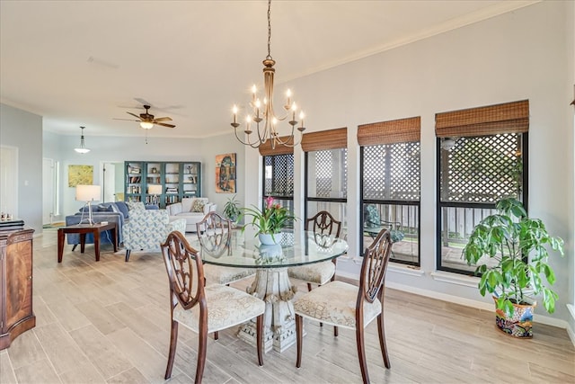 dining area with ceiling fan with notable chandelier, light wood-type flooring, and crown molding