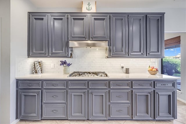 kitchen featuring stainless steel gas cooktop, decorative backsplash, and light tile patterned floors