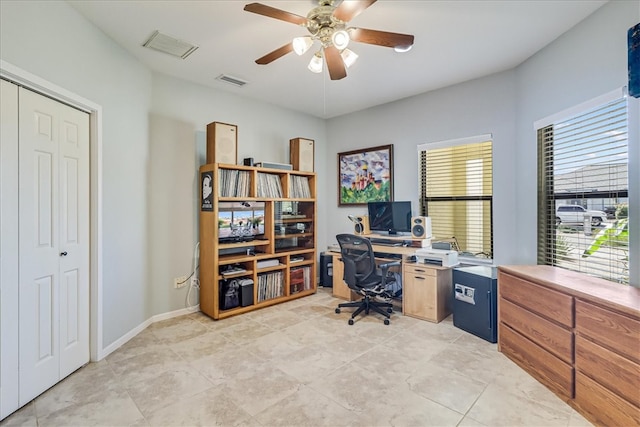 tiled office space featuring ceiling fan