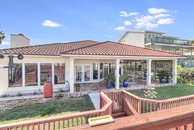 back of property featuring a yard, a patio, and french doors